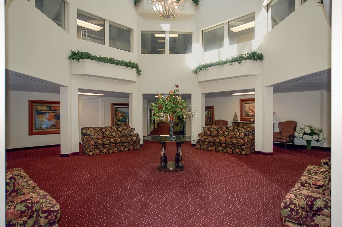 Spacious hotel lobby with elegant decor and seating arrangements.