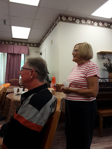 A lively gathering in a community center where two individuals engage in conversation.