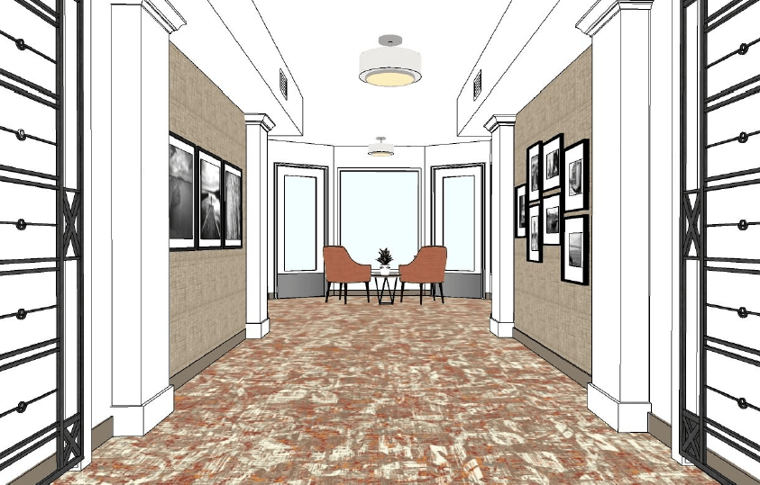 A modern hallway design with artwork on the walls and a cozy seating area at the end.