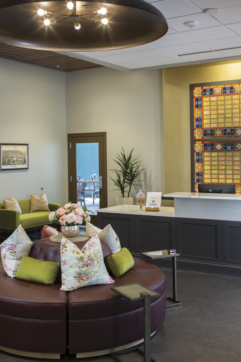 A modern reception area with comfortable seating and decorative elements.