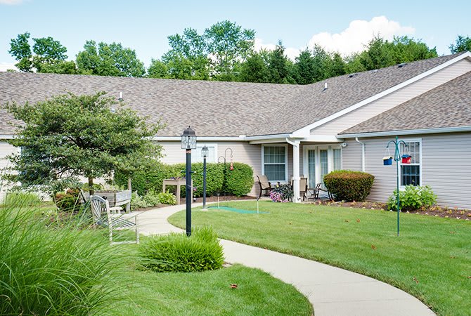 A suburban home with a well-maintained lawn and garden path.