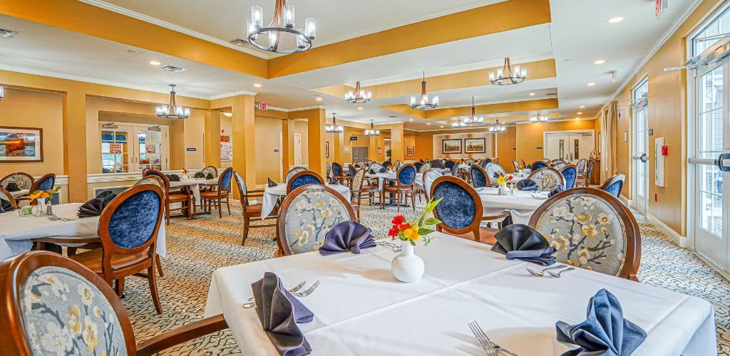 An elegant restaurant dining room with beautifully set tables and classic decor.