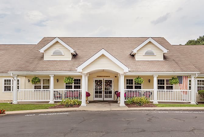 A charming residential building with a porch and symmetrical design.