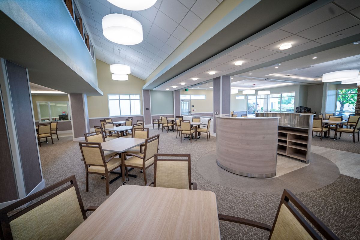 A modern and spacious dining area with neatly arranged tables and chairs.