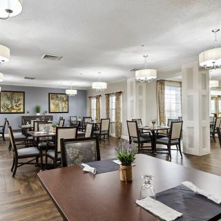 Elegant dining area with arranged tables and modern lighting.