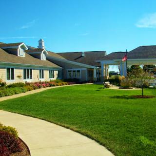 A well-maintained building surrounded by lush green grass and a scenic pathway.