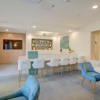 A modern lounge area with a sleek bar counter and stylish seating.