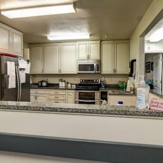 A view of a modern kitchen showcasing various appliances and ample storage.