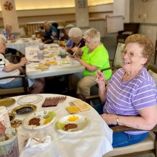 Seniors enjoying a meal together at a community dining event.