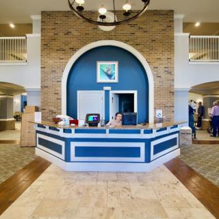 A modern hotel lobby with a stylish reception desk and elegant decor.