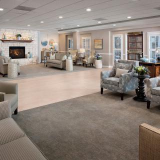 A modern and spacious living room with comfortable seating and a fireplace.