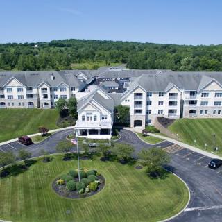 Aerial view of a residential apartment complex surrounded by landscaped greenery.