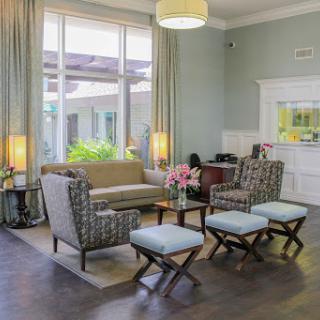 A cozy and modern lounge area with comfortable seating and ample natural light.