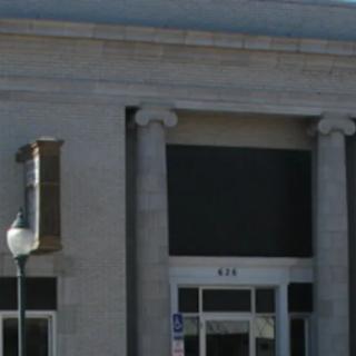 An old building with classical columns and an entrance.