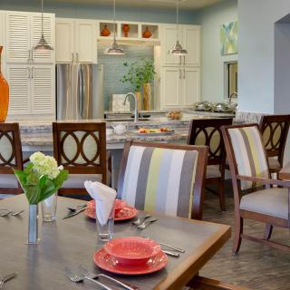 A modern dining area with a well-decorated table, adjacent to a stylish kitchen.