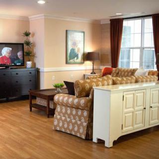 A cozy living room interior with comfortable seating and a television.