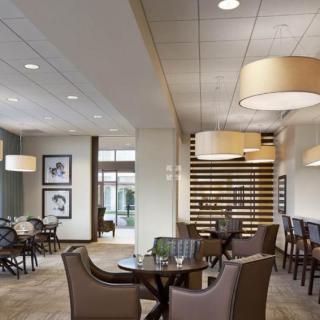 A modern restaurant interior with elegant lighting and comfortable seating.