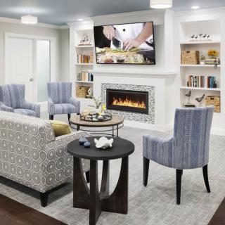 A modern living room with comfortable seating and a cozy fireplace.