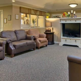 Cozy living room with comfortable seating and a large television.
