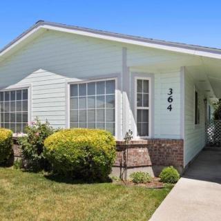 A single-story suburban house with a well-maintained front yard and driveway.