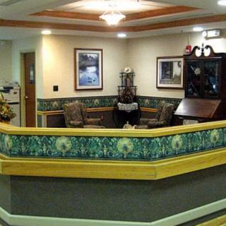 A reception area with a front desk, seating, and decorative elements.