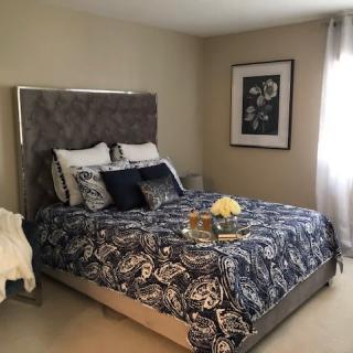 A beautifully decorated bedroom with a stylish bed and elegant decor.