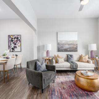 A modern living room with stylish decor, featuring a comfortable sofa, armchair, and chic coffee table.