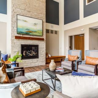 A modern living room with stylish decor, featuring a fireplace and comfortable seating.