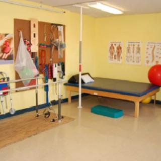 A physical therapy room equipped with exercise tools and rehabilitation equipment.