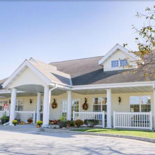 A charming suburban house with a large porch and well-maintained exterior.