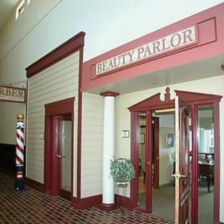 The entrance to a beauty parlor, featuring classic decor and a barber pole.