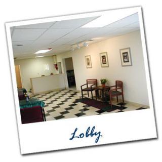 A clean and organized lobby area with a reception desk and seating.