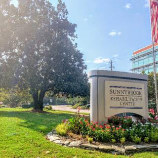 A welcoming view of the Sunstone Physical Therapy center, surrounded by greenery and bright skies.