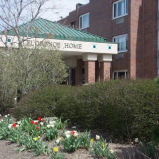 Entrance of a residential building with landscaped garden.