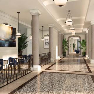 Elegant hallway with stylish lighting, artwork, and seating areas.