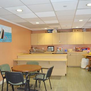 A cozy break room with kitchen facilities and seating arrangements.