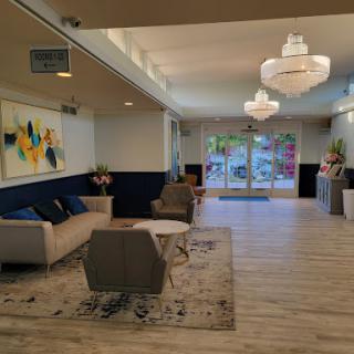A modern lobby featuring stylish furniture, contemporary art, and ample natural light.