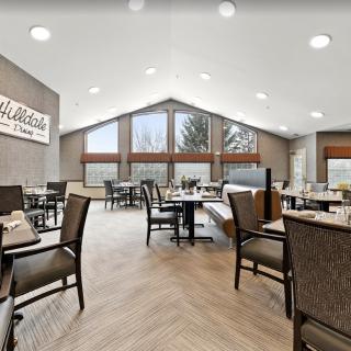 A modern restaurant dining area featuring large windows and contemporary decor.