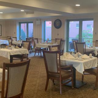 An empty dining room with neatly set tables and chairs.