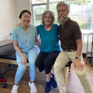 Celebrating progress in physical therapy with a supportive team.