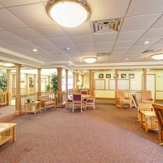 A spacious waiting area with seating and warm lighting.