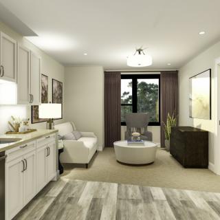 A modern living room with neutral decor and a connected kitchen area.