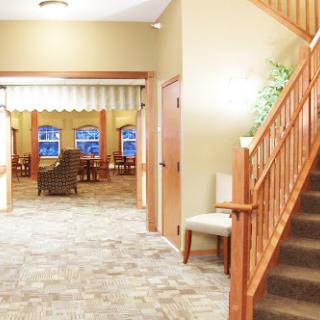 A welcoming lobby area with a staircase, comfortable seating, and warm decor.