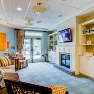 A cozy living room with a fireplace, television, and comfortable seating.