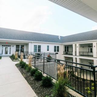 A serene courtyard showcasing modern architecture and well-maintained landscaping.