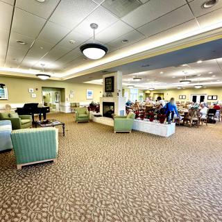 A spacious and well-lit lounge area with comfortable seating and a communal atmosphere.