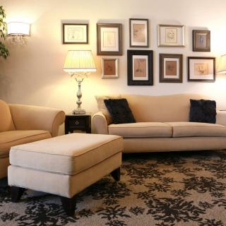 A cozy living room with stylish furniture and wall art.