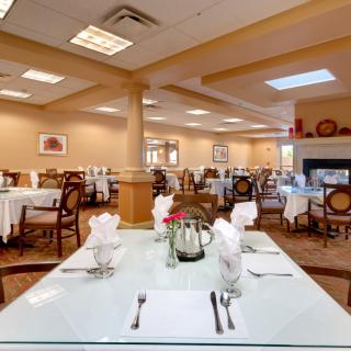 A well-arranged dining area with neatly set tables and elegant decor.