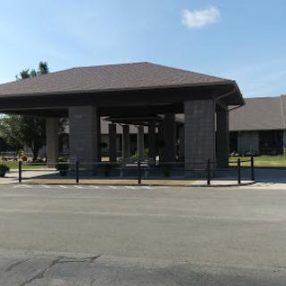 A modern architectural entrance with a shaded canopy.