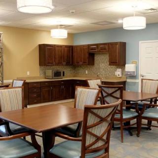 A cozy kitchen and dining area with wooden furniture and soft lighting.